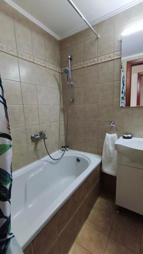 a bathroom with a bath tub and a sink at PERLA apartment in Alexandroupoli