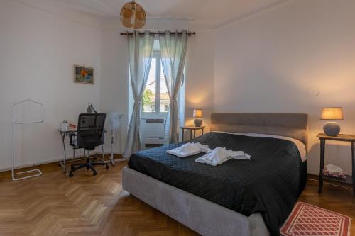 a bedroom with a bed and a chair and a window at Vista&Capriccio in Trieste