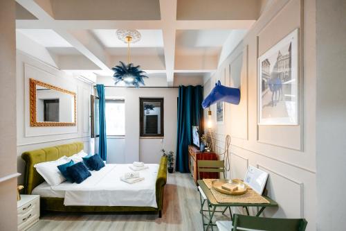 a small room with a bed and a table at Blue Camel in Old Town in Bucharest