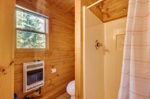 a bathroom with a toilet and a window at Remote Escape Vermont Cabin with Mountaintop Views! in Sharon