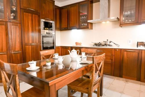 a kitchen with a wooden table with chairs and appliances at Mediterranean Villa in St. Paul's Bay