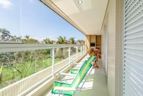 a balcony with chairs and a view of the ocean at 200m da praia com Piscina ,churrasqueira e Jacuzzi in Bertioga