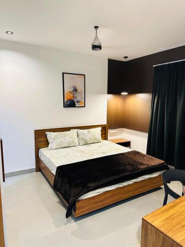a bedroom with a large bed in a room at ZAHIR RESIDENCY calicut in Kozhikode