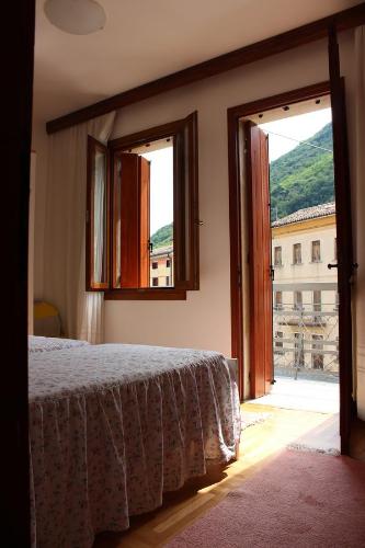 a bedroom with a bed and a large window at Casa Nonna Teresa in Tovena