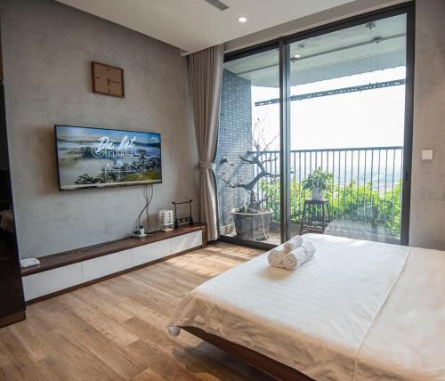 a bedroom with a large bed and a large window at Mộc Room Ecopark in Kim Quan