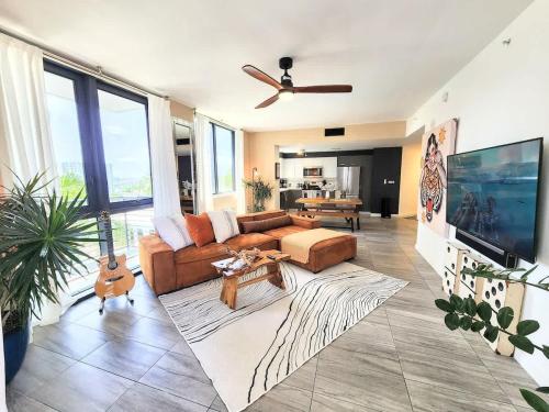 a living room with a couch and a table at Lux Style Boho Retreat PRIME LOCATION in Miami