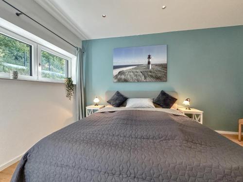 a bedroom with a bed and a lighthouse painting on the wall at Wolfring in Fensterbach