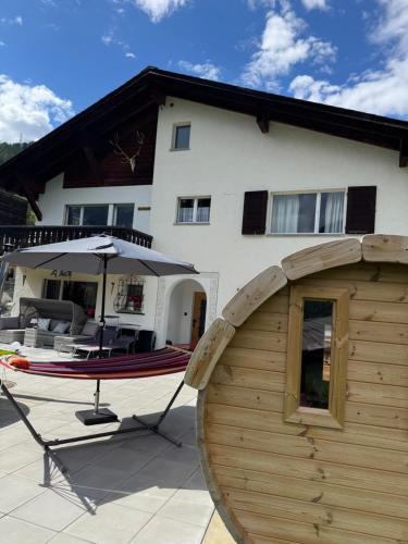 a boat sitting in front of a house at Berg-Bijou Scuol in Scuol