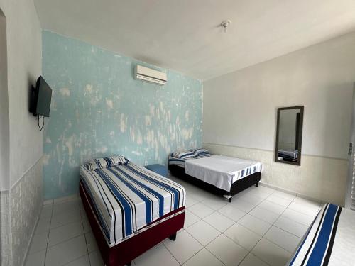 Postel nebo postele na pokoji v ubytování Pousada e hostel Costa do Sol Coroa Vermelha