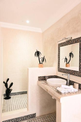 a bathroom with a sink and a mirror at Berber Shelter in Tamraght Ouzdar