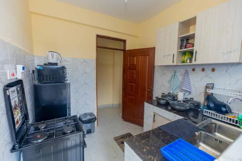 a kitchen with a sink and a stove top oven at Marvel Homes in Ruiru