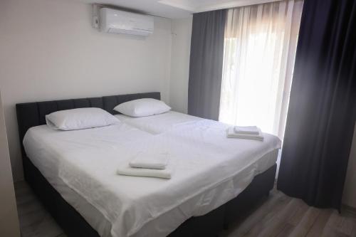 a bedroom with a bed with two towels on it at lamoza in Narlıdere