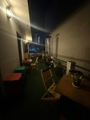 a dark room with chairs and tables in a restaurant at HBB Hostel Brasil Bar- Vila Madalena - São Paulo-SP - Próximo a Beco do Batman, Paulista, Allianz Parque, Morumbi, Acesso 24hs in São Paulo