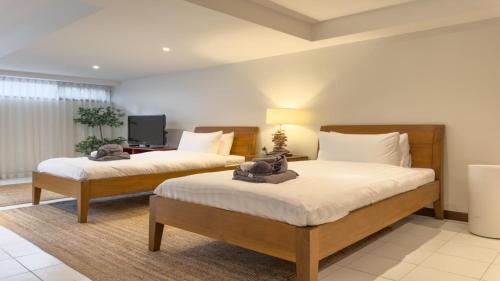 Ένα ή περισσότερα κρεβάτια σε δωμάτιο στο Tropical Poolside Villa - SGB4