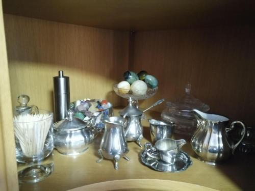 a shelf with various glass vases and a bowl of eggs at Elegantes Haus, Bikes, ruhig, Garten, Seenähe, ab 6 Jahre in Starnberg