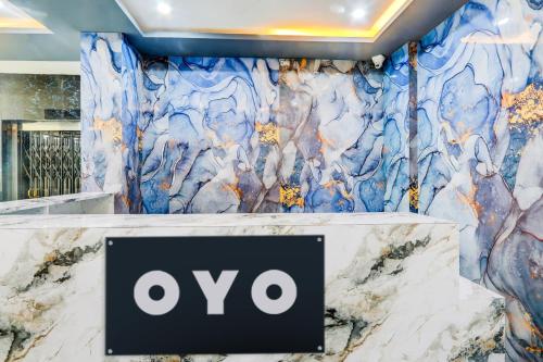 a sign in front of a marble wall at Hotel O Grand stay hotels in Karīmnagar