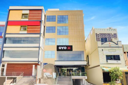 an apartment building with an ovo sign on it at Hotel O Grand stay hotels in Karīmnagar