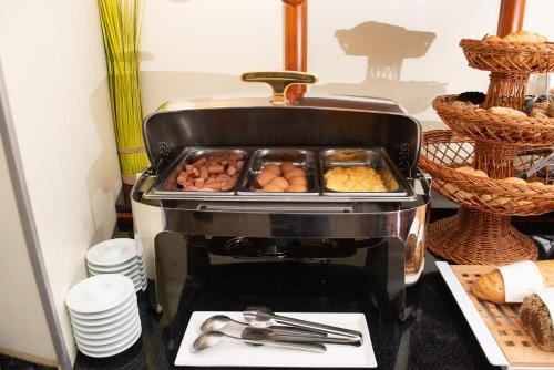a grill with a tray of food on top of it at Suite Hotel 900 m zur Oper in Vienna