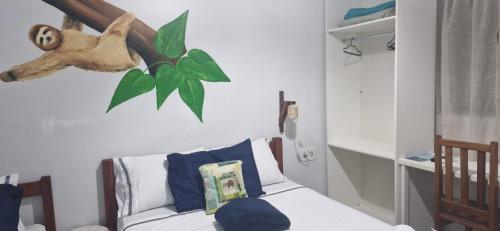 a room with a bed with a monkey head on the wall at Pousada Sorriso da Mata.. in Alter do Chao
