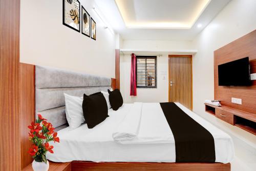 a bedroom with a large bed and a television at Hotel O Shri Vinayak in Shamsgarh