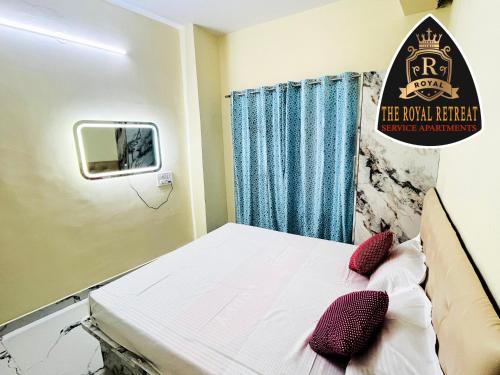 a hospital room with a bed with red pillows at THE ROYAL RETREAT service apartment in Chikmagalūr