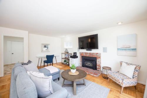 a living room with a couch and a fireplace at Entire Oceanview Coastal Retreat in Pacifica in Pacifica