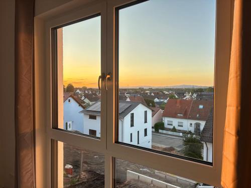 an open window with a view of a city at Modern, new home with air cooling in Kindsbach