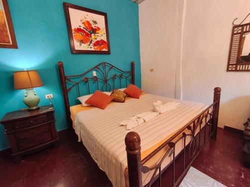 a bedroom with a large bed with orange pillows at Las Catalinas Anton Panama in Antón