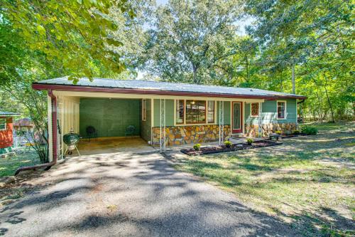 a small house with a dog in front of it at Near State Park and Spring River Family Gem with Yard in Mammoth Spring