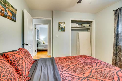 a bedroom with a bed with an orange bedspread at Near State Park and Spring River Family Gem with Yard in Mammoth Spring