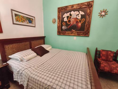 a bedroom with a bed and a painting on the wall at Las Catalinas Anton Panama in Antón