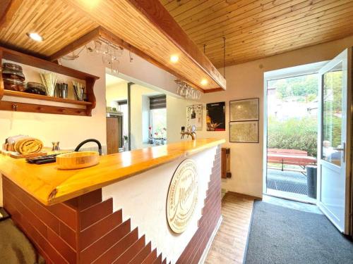a kitchen with a wooden counter top in a room at Chata WALTEROVKA in Josefuv dul