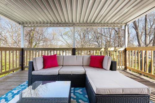 a patio with a couch on a wooden deck at Retro Mid-Mod Gem in Bristol * Fully Renovated in Bristol