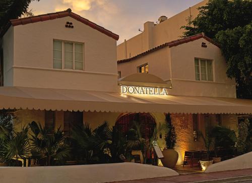 a building with a sign that reads doorkminster at Donatella Boutique Hotel in Miami Beach