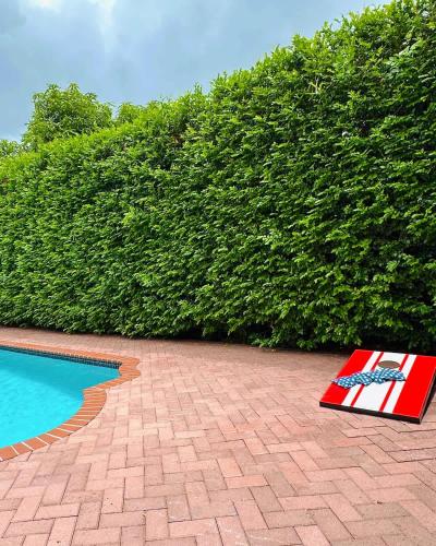 a book sitting on the ground next to a swimming pool at Miami home -15min from Kendall Exec Airport - Pool in Hammocks