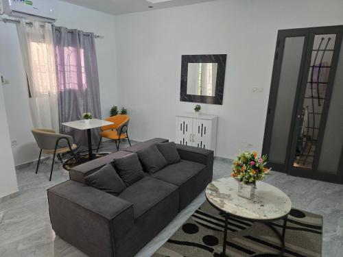 a living room with a couch and a table at SUITE RESIDENCE TERANGAWALo in Richard Toll