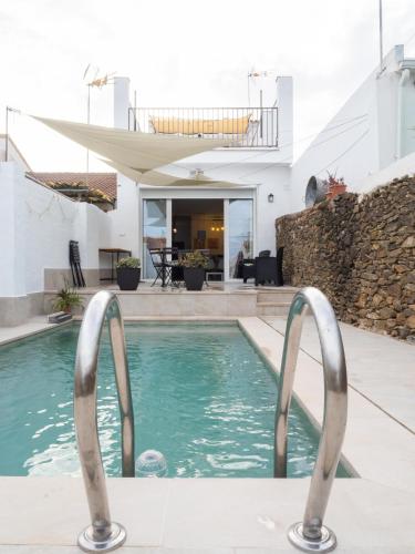 a swimming pool with two metal handles in a house at Casa Lucas Andrew 