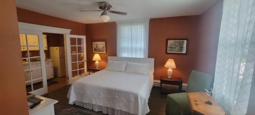 a bedroom with a bed and a ceiling fan at Captain Hugo's Guesthouse STR26-36 in Rockland