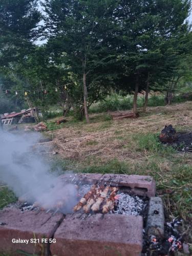 a fire grill with smoke coming out of it at Happy Buriani in Buriaki