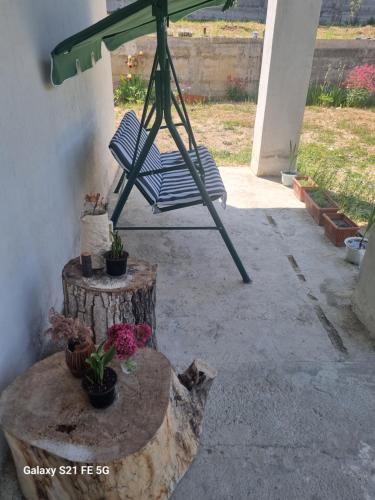 a chair sitting under an umbrella on a patio at Happy Buriani in Buriaki