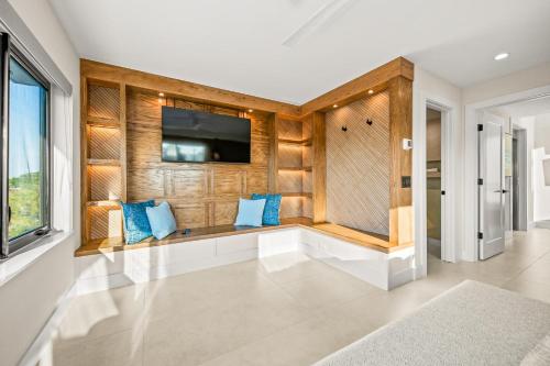 a living room with a bench with blue pillows at Knot A Basic Beach House in Bailey Hall
