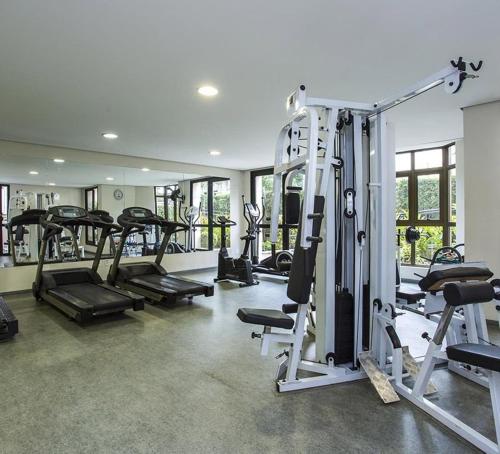 a gym with a bunch of tread machines in it at Flat Residencial Moema garagem internet limpeza e sacada in Sao Paulo