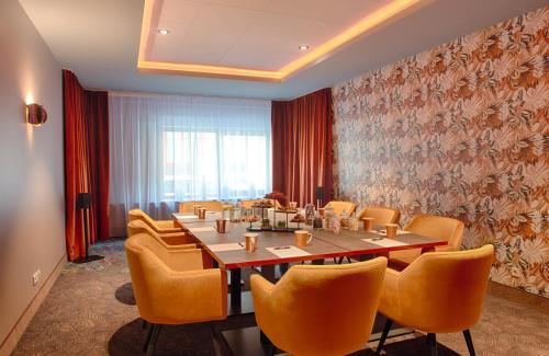 a conference room with a long table and chairs at NYX Hotel Mannheim by Leonardo Hotels in Mannheim