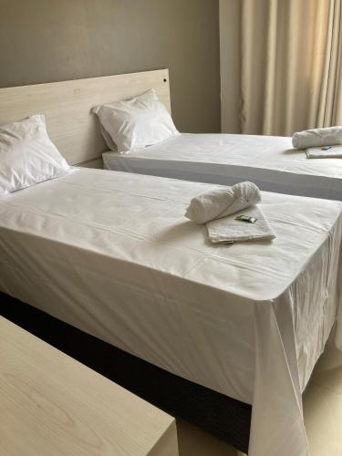 Postel nebo postele na pokoji v ubytování Kuri Hotel