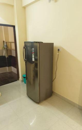a stainless steel refrigerator sitting in a room at Shreya's Homestay, Your Sacred Nest in Ujjain