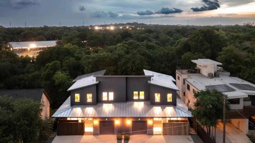 a house with lights on top of a building at Full Duplex ATX Modern Creekside Retreat 2 Pools in Austin