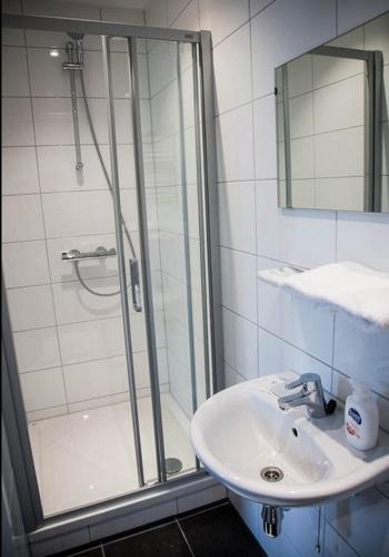 a bathroom with a shower and a sink at Spectacular azure ocean views in West Bay