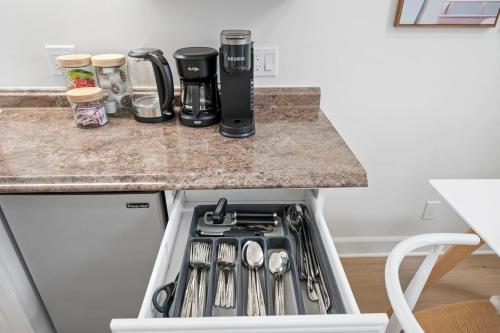 a kitchen with a stove top oven next to a counter at Miramar Penthouse Coastal Elegance in the Heart of Half Moon Bay in Half Moon Bay