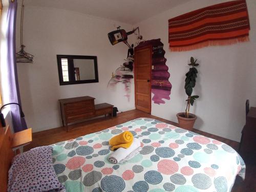 a bedroom with a bed with a stuffed animal on it at Hostal Po in Valparaíso
