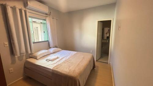 Ένα ή περισσότερα κρεβάτια σε δωμάτιο στο Casa Aconchegante e bem localizada, Ideal para Famílias e Grupos